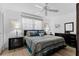 Cozy bedroom with a ceiling fan, natural light, and coordinated decor at 6070 80Th N St # 308, St Petersburg, FL 33709