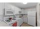 Bright kitchen featuring white cabinets, appliances, and a gas stovetop at 6070 80Th N St # 308, St Petersburg, FL 33709