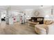 Open-concept living room and kitchen showcasing natural light and neutral decor at 6070 80Th N St # 308, St Petersburg, FL 33709