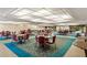 Spacious lounge area with multiple tables, chairs, and scenic views at 6070 80Th N St # 308, St Petersburg, FL 33709