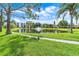 Beautiful pond view with a fountain surrounded by lush green landscaping on a sunny day at 6070 80Th N St # 308, St Petersburg, FL 33709