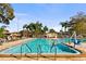 Enjoy the community pool with lounge chairs and clear blue water on a sunny day at 6070 80Th N St # 308, St Petersburg, FL 33709