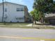 Well-maintained condo building with awnings, tidy landscaping, and convenient street access at 6100 21St N St # 17, St Petersburg, FL 33714