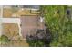 Birds-eye view of a single-Gathering home with a large roof, driveway, and surrounding trees at 6204 Nebraska Ave, New Port Richey, FL 34653