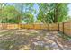 Spacious backyard surrounded by a tall wooden fence, perfect for privacy and outdoor activities at 6204 Nebraska Ave, New Port Richey, FL 34653