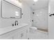 Updated bathroom with black fixtures, white vanity, and updated shower at 6204 Nebraska Ave, New Port Richey, FL 34653