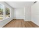 Clean bedroom featuring modern wood-look flooring, light walls, and a bright window at 6204 Nebraska Ave, New Port Richey, FL 34653