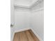 Walk-in closet with wood-look floors and basic rack for storage at 6204 Nebraska Ave, New Port Richey, FL 34653