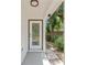 Close-up of a stylish front door, showcasing glass inserts, a modern handle, and clean architectural lines at 6204 Nebraska Ave, New Port Richey, FL 34653