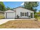 Charming single-story home featuring a well-manicured lawn, a garage, and freshly painted exterior at 6204 Nebraska Ave, New Port Richey, FL 34653