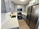 Modern kitchen with ample cabinets, quartz countertops, stainless steel appliances, and a view from the window at 6204 Nebraska Ave, New Port Richey, FL 34653