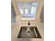 Close up of kitchen sink and stone countertops with bright window to living area at 6204 Nebraska Ave, New Port Richey, FL 34653