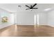 Bright and airy living room featuring neutral walls, wood-look floors, and an open layout, perfect for relaxation at 6204 Nebraska Ave, New Port Richey, FL 34653