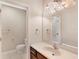 Bathroom vanity with a decorative light fixture, large mirror and tile flooring at 7410 S Fitzgerald St, Tampa, FL 33616