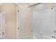 Bathroom with a white shower and tub combination, complemented by tiled walls at 7410 S Fitzgerald St, Tampa, FL 33616