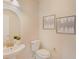 Stylish half-bathroom with a modern vanity, neutral tones, and decorative wall art at 7410 S Fitzgerald St, Tampa, FL 33616