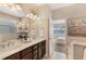 Bathroom with double sinks and a view of the Primary bedroom and stand alone bathtub at 7410 S Fitzgerald St, Tampa, FL 33616