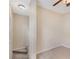 Bright bedroom with neutral tones, carpet, and a ceiling fan, leading to stairs at 7410 S Fitzgerald St, Tampa, FL 33616