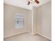 Well-lit carpeted bedroom with a ceiling fan and a bright window at 7410 S Fitzgerald St, Tampa, FL 33616