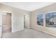 Carpeted bedroom featuring an open closet and a window with neighborhood views at 7410 S Fitzgerald St, Tampa, FL 33616