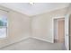 Sunlit carpeted bedroom with a window view and open door at 7410 S Fitzgerald St, Tampa, FL 33616