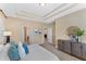 Spacious bedroom with tray ceiling, a large window, and ample closet space at 7410 S Fitzgerald St, Tampa, FL 33616
