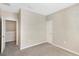 Spacious carpeted bedroom with an open doorway to a walk-in closet at 7410 S Fitzgerald St, Tampa, FL 33616
