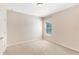Bright bedroom features neutral carpet, a window with blinds, and a ceiling light at 7410 S Fitzgerald St, Tampa, FL 33616