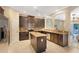 Well-equipped kitchen with dark wood cabinets, stainless steel appliances, and a convenient center island at 7410 S Fitzgerald St, Tampa, FL 33616
