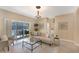 Bright living room with sliding glass doors, neutral décor, and a comfortable seating arrangement at 7410 S Fitzgerald St, Tampa, FL 33616