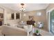 Cozy living room featuring neutral tones, elegant furnishings, and an open layout to the kitchen at 7410 S Fitzgerald St, Tampa, FL 33616