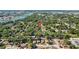 Aerial view of the neighborhood shows homes nestled among lush trees and vegetation at 7603 Rhode Island Dr, Tampa, FL 33619