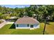 Aerial view of home with lush backyard, and mature trees in a quiet neighborhood at 7603 Rhode Island Dr, Tampa, FL 33619