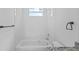Elegant bathroom featuring marble-like tile, sleek fixtures, and a modern bathtub at 7603 Rhode Island Dr, Tampa, FL 33619