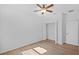 This bedroom offers a ceiling fan, wood-look flooring, a closet and interior door at 7603 Rhode Island Dr, Tampa, FL 33619
