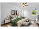 Bright bedroom features neutral walls, wood floors, ceiling fan, and modern decor at 7603 Rhode Island Dr, Tampa, FL 33619