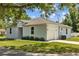Exterior view of a light-colored single-Gathering home with attached garage at 7603 Rhode Island Dr, Tampa, FL 33619