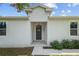 Inviting entryway featuring a chandelier and a stylish dark-colored front door at 7603 Rhode Island Dr, Tampa, FL 33619