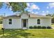 Charming single-story home featuring a well-manicured lawn, fresh exterior paint, and modern details at 7603 Rhode Island Dr, Tampa, FL 33619