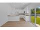 This kitchen has granite countertops and modern appliances, with a sliding door to the backyard at 7603 Rhode Island Dr, Tampa, FL 33619
