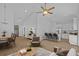 Open-concept living room showcases vaulted ceilings, modern furniture, and seamless flow into the kitchen area at 7603 Rhode Island Dr, Tampa, FL 33619