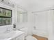 Bright white bathroom featuring a shower/tub combo and neutral accents at 8114 N 11Th St, Tampa, FL 33604