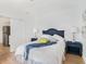 Comfortable bedroom featuring a blue headboard, matching side tables, and a calming decor at 8114 N 11Th St, Tampa, FL 33604
