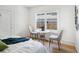 Bright bedroom with a table and chairs near a large window overlooking the backyard at 8114 N 11Th St, Tampa, FL 33604