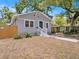 Attractive single-story home with a blue front door and manicured front yard at 8114 N 11Th St, Tampa, FL 33604