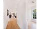 Bright hallway leads to an open floor plan featuring a kitchen and living area at 8114 N 11Th St, Tampa, FL 33604