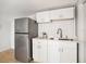 A compact kitchen area with stainless steel appliances and white cabinetry for a modern aesthetic at 8114 N 11Th St, Tampa, FL 33604