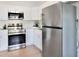 Bright kitchen with white cabinetry, stainless steel appliances, and light wood flooring at 8114 N 11Th St, Tampa, FL 33604