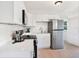 Modern kitchen featuring white cabinets, quartz countertops, and stainless steel appliances at 8114 N 11Th St, Tampa, FL 33604