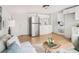 Open-concept living space with a small kitchen, modern appliances, and a cozy sitting area at 8114 N 11Th St, Tampa, FL 33604